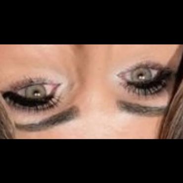 Close-up of a person's eyes with dramatic makeup, shown upside down.