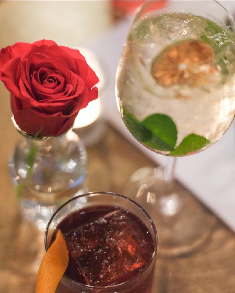A rose and drinks served in wine glasses at Alfredo's Pastaria and Mozzarella Bar.