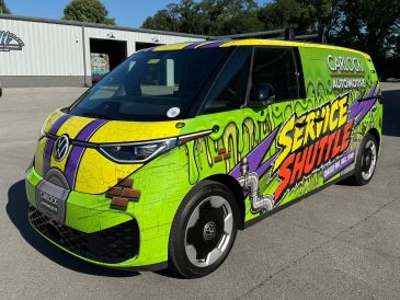 Colorful Volkswagen service shuttle van with vibrant graphics.