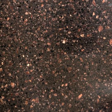 Close-up of polished terrazzo surface with copper and black aggregates.