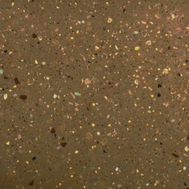 Close-up of terrazzo floor with multicolored stone chips in brown matrix.