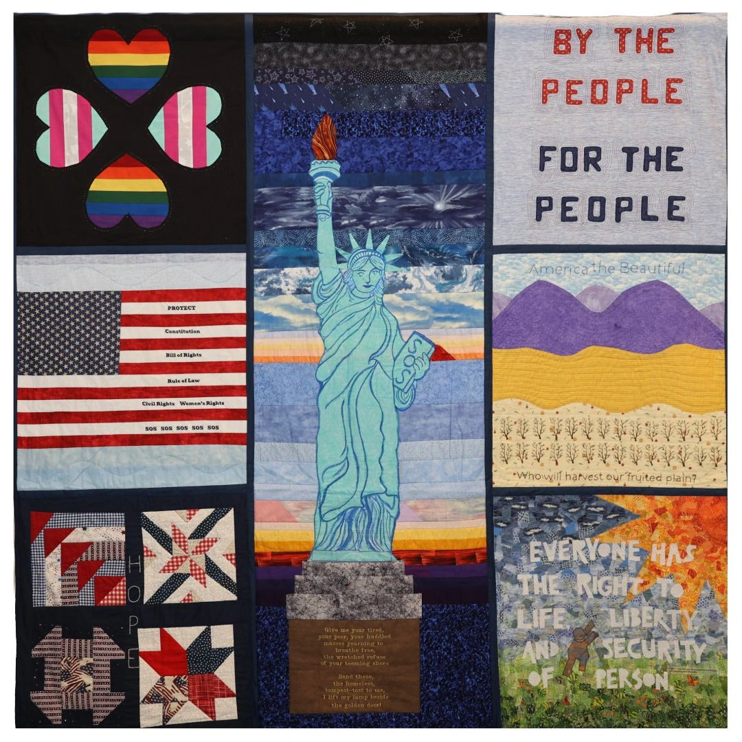 Quilt featuring the Statue of Liberty, American flag, and social justice messages.