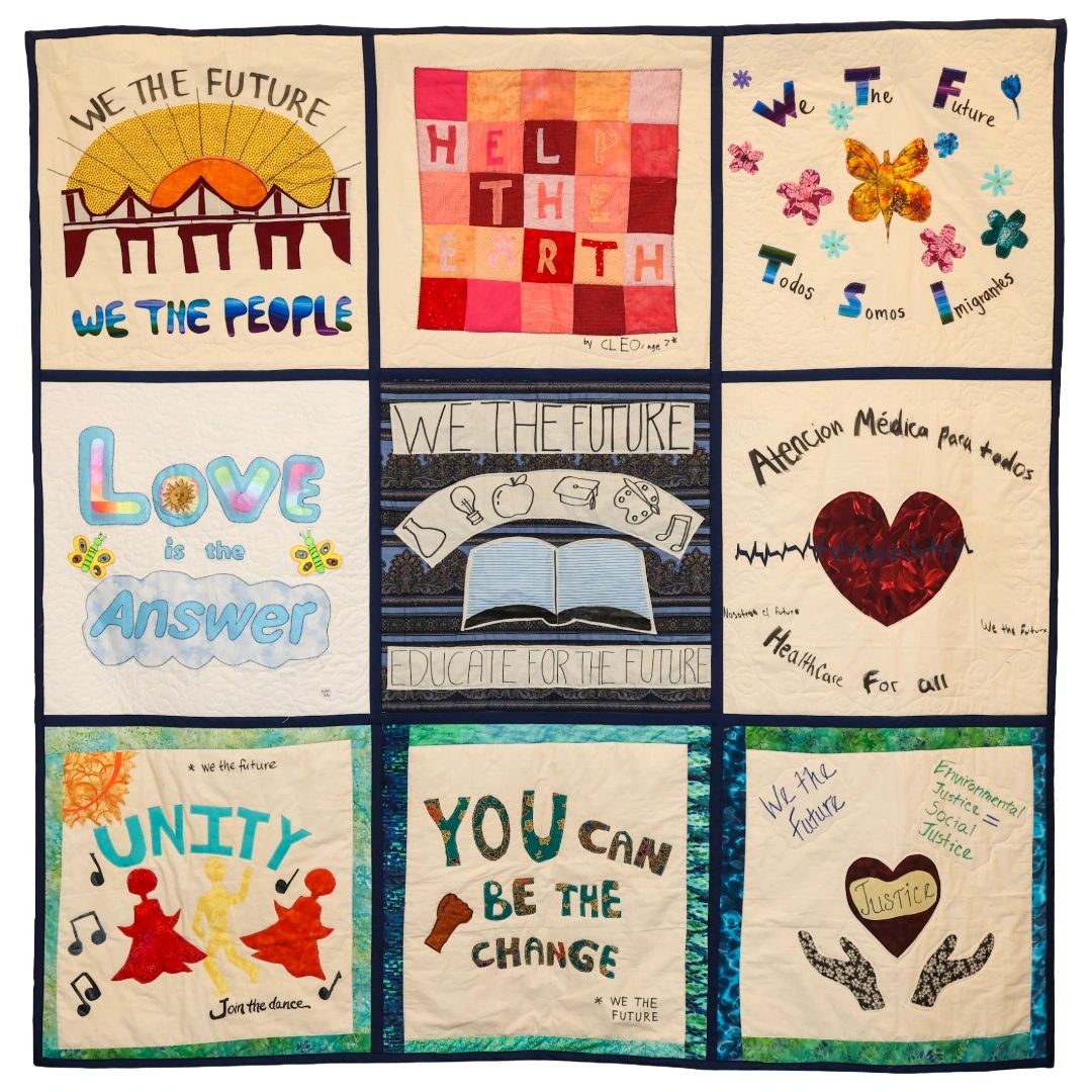 Quilt with positive messages about future, unity, love, and justice.