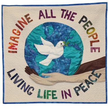 Quilt with a dove and globe, symbolizing peace and unity.