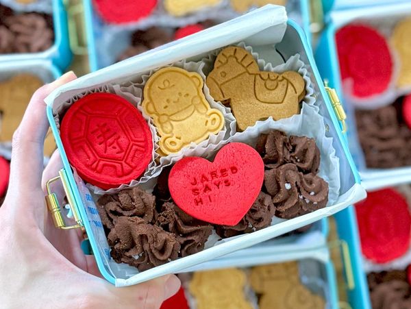 A box of colorful cookies and chocolate candy.
