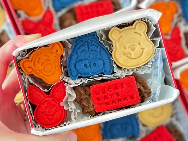 Colorful character cookies packaged in a gift box.