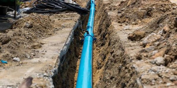 Blue pipeline installed in a trench.