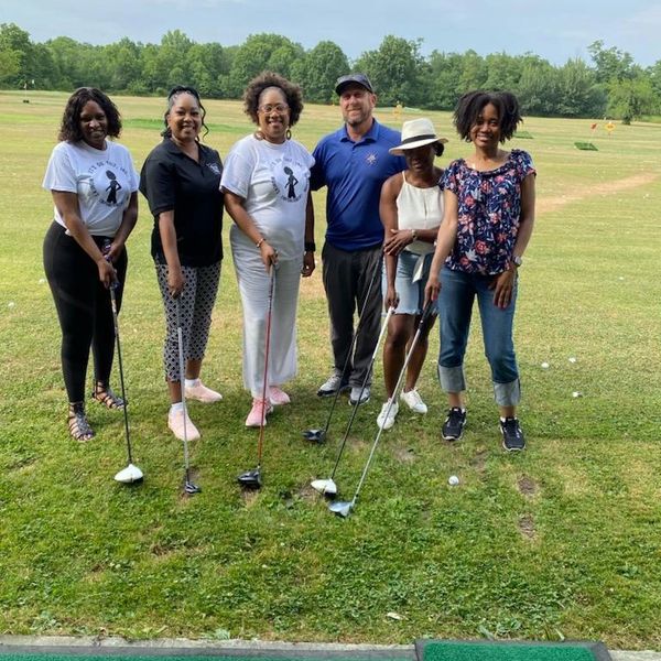 a group of people at a golf course