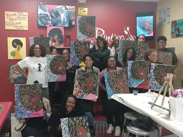 a group of people holding paintings