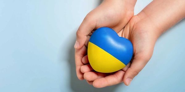 hands with heart shape of Ukrainian colors