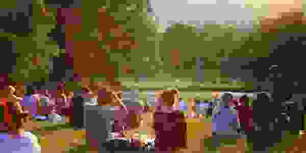 Community of people sitting in a park
