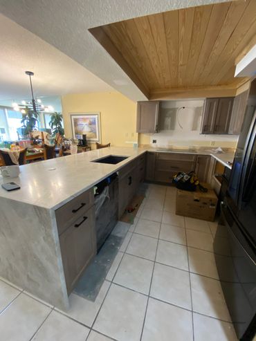Modern kitchen under renovation with new countertops and cabinets.