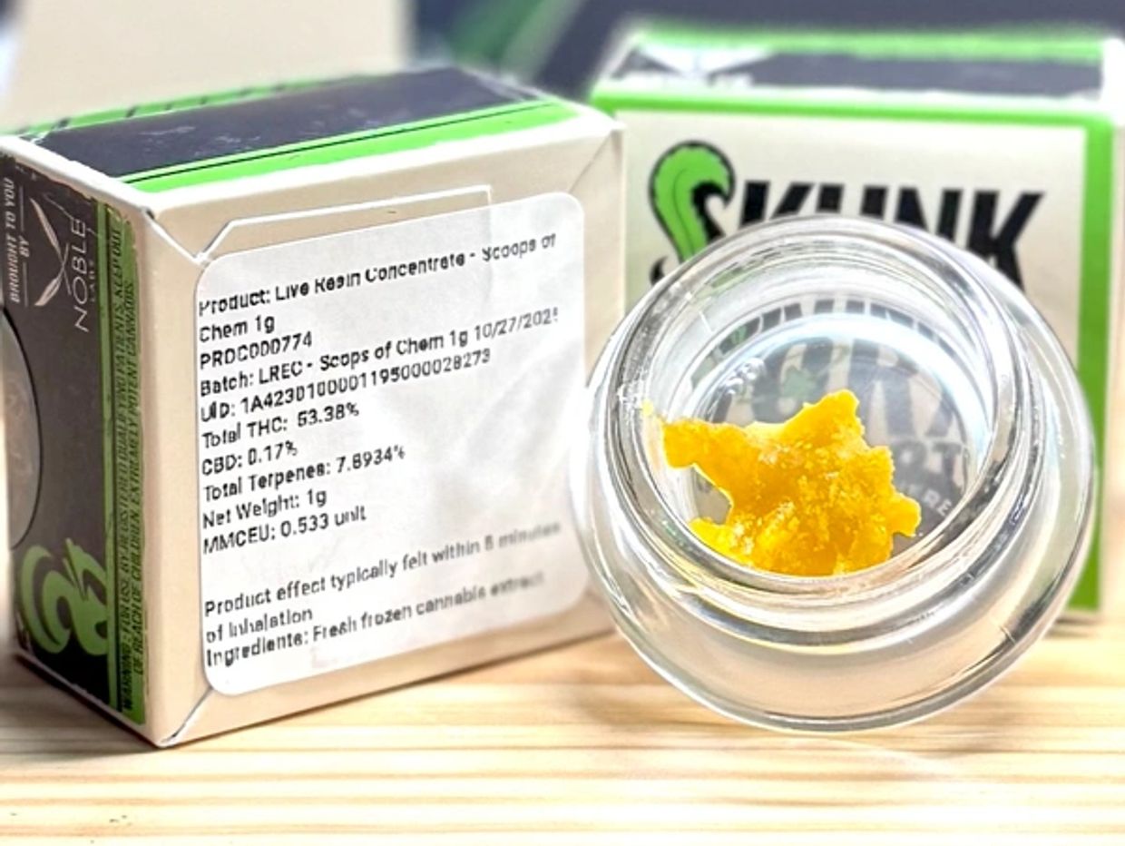 Live Resin Concentrate with yellow cannabis extract in jar.