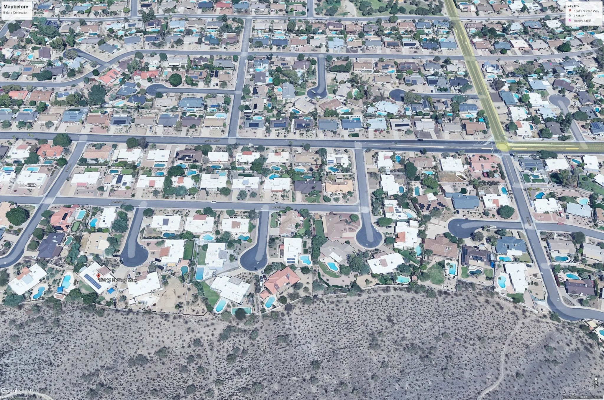 Aerial view of a suburban neighborhood with houses and swimming pools.