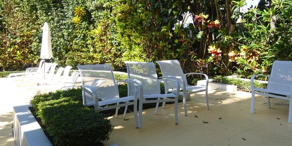 Dunster House, 360 South Ocean Blvd., Palm Beach, view information and mls listings, condos for sale, pool, chairs by pool, Jacqueline Zimmerman, Realtor (561) 906-7153, Adam Zimmerman, Realtor (561) 906-7152.