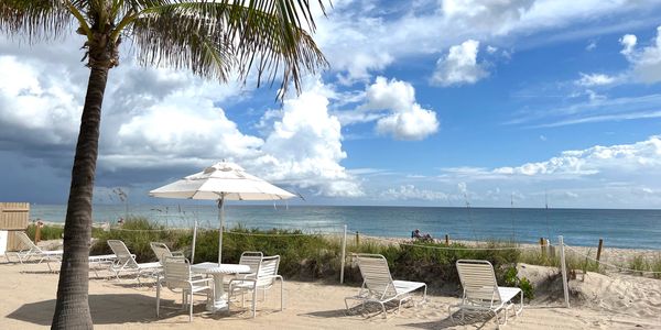 Ocean Towers, Palm Beach, beach with white chairs, table, umbrellas