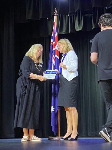 Former Club Secretary Faye Brutlag receives the 2022 Volunteer award from Angie Bell MP for Moncrief