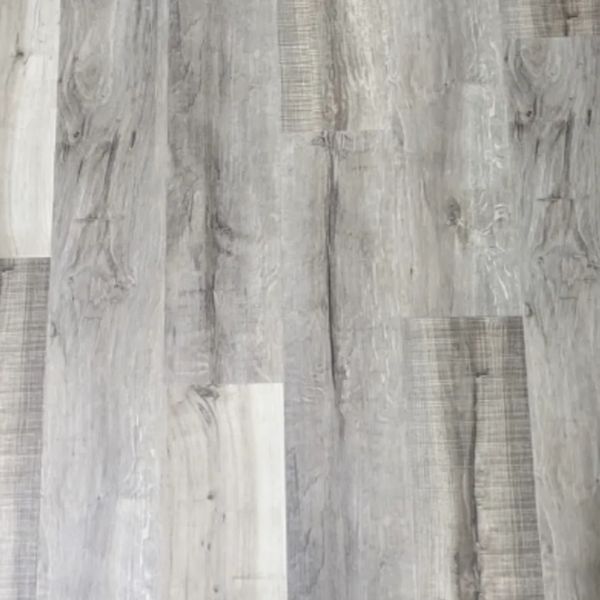 Close-up of gray wood-patterned laminate flooring with varied tones.
