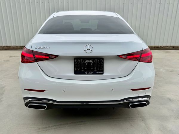 Rear view of a white Mercedes-Benz C 220d parked on concrete.