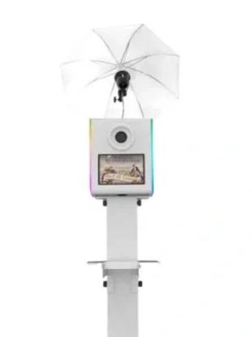 Modern photo booth with umbrella lighting and touchscreen display.