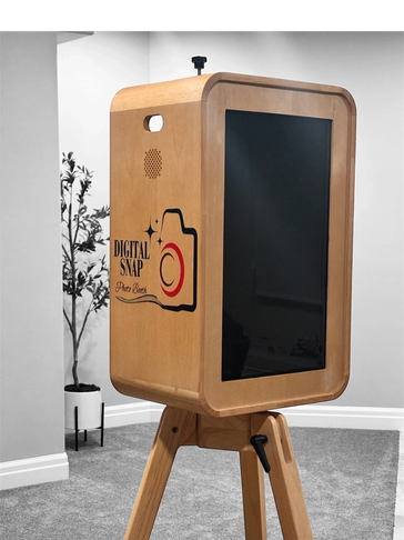 Wooden digital photo booth on tripod with black screen.