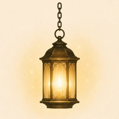 Vintage brass lantern hanging with glowing candle inside.