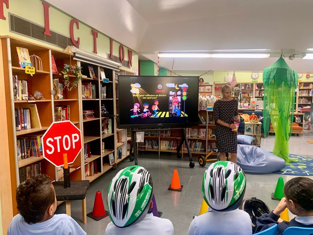 Kids learning about bike safety in a library.