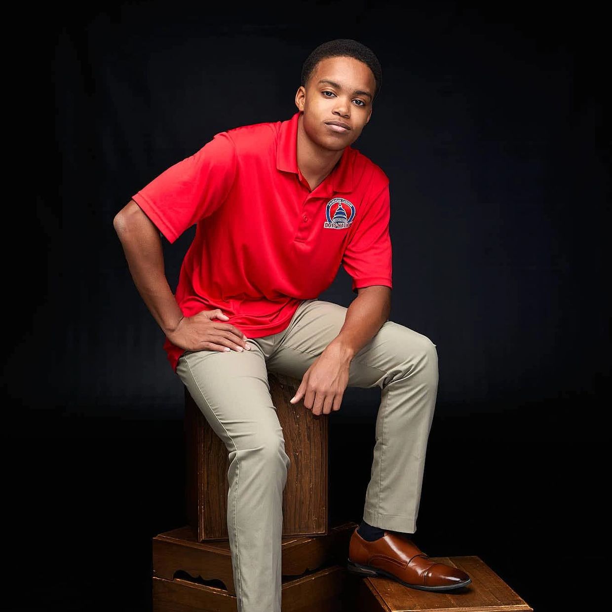 Jayden on a stool with his Boys Nation shirt on.