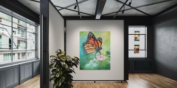 Modern gallery room with butterfly painting and potted plant.