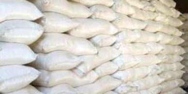 Stacks of white sacks piled high in a storage area.