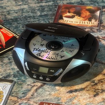 Portable CD player with a handwritten CD inside.