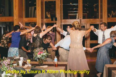 Guests "Thread the Needle" in a Barn Dance Segment of a Wedding Reception