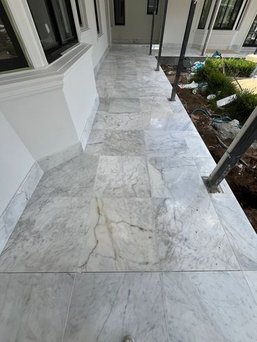 Polished marble floor tiles in a corridor under construction.