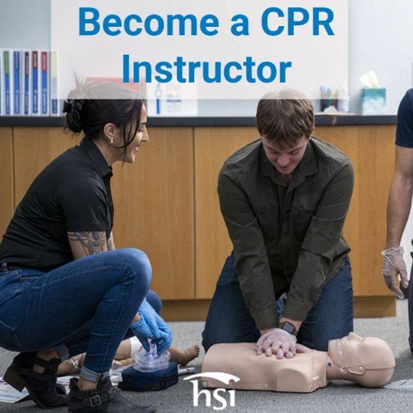 People practicing CPR on a training manikin in a classroom setting.