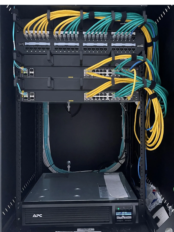 IDF rack with two 24 port fiber switches and a loaded 48 port patch panel. 