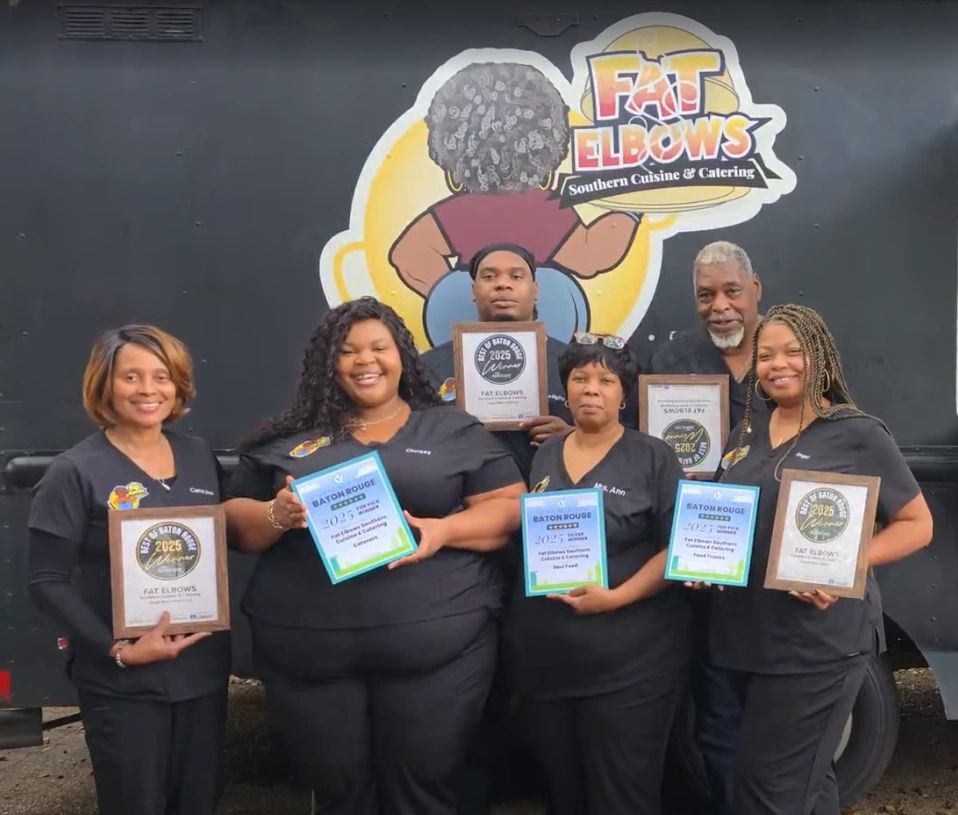 Group photo of six people holding awards in front of Fat Elbows food truck.