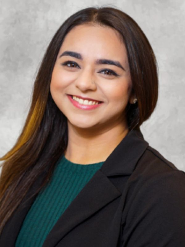 Smiling woman with long dark hair and a black blazer.