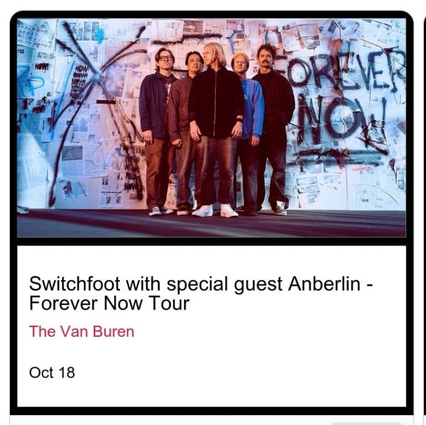 Switchfoot band members stand in front of a wall with graffiti for a tour announcement.
