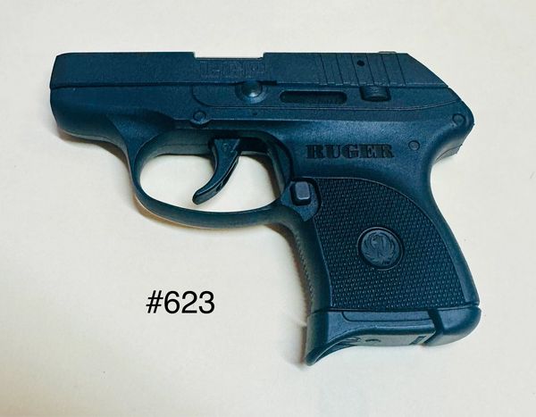 Black Ruger semi-automatic handgun on a white surface with #623 text.