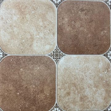 Close-up of a tiled floor with four square tiles in beige and brown shades.