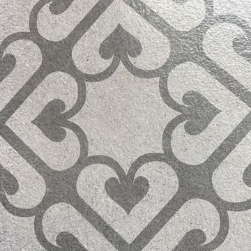 Gray and white geometric pattern featuring heart shapes on a textured surface.