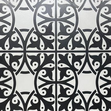 Black and white decorative tiles with symmetrical floral patterns.