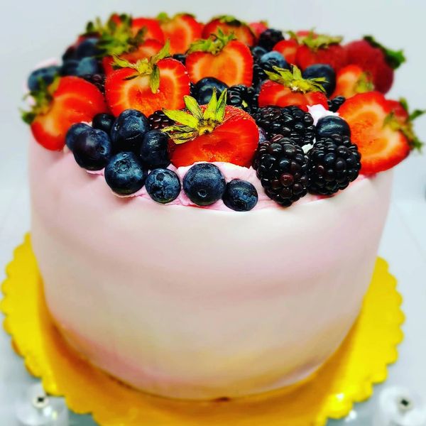 Summer fruit vanilla cake filled with berry flavored frosting. 