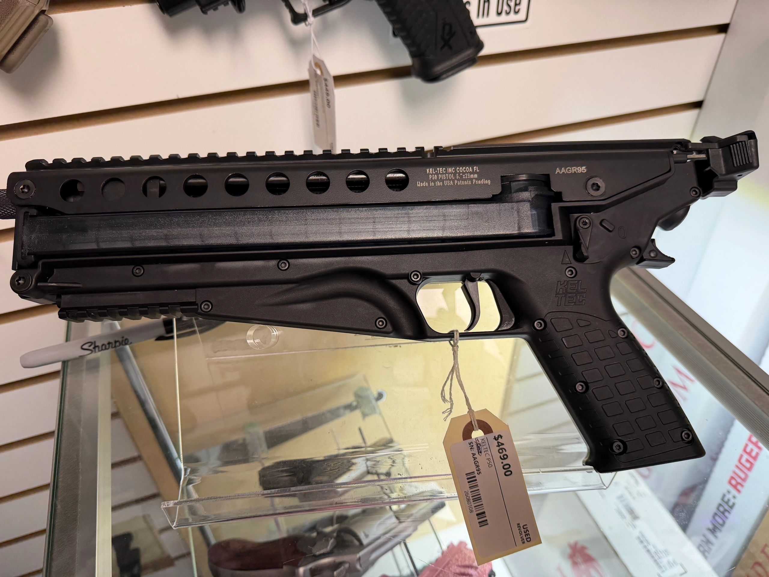 Close-up of a Kel-Tec P50 pistol with price tag.