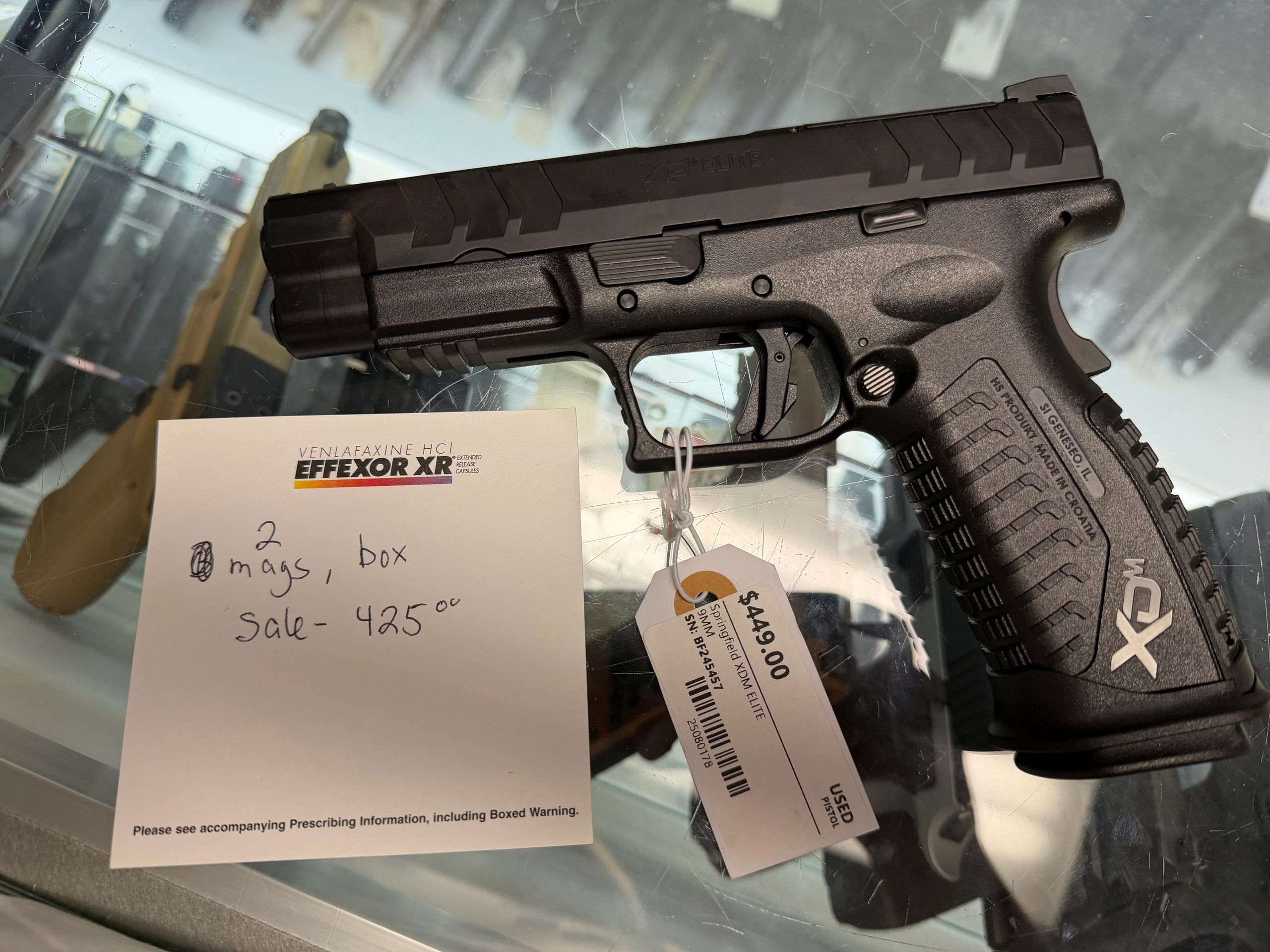 Black Springfield XDM Elite pistol with price tag and note.