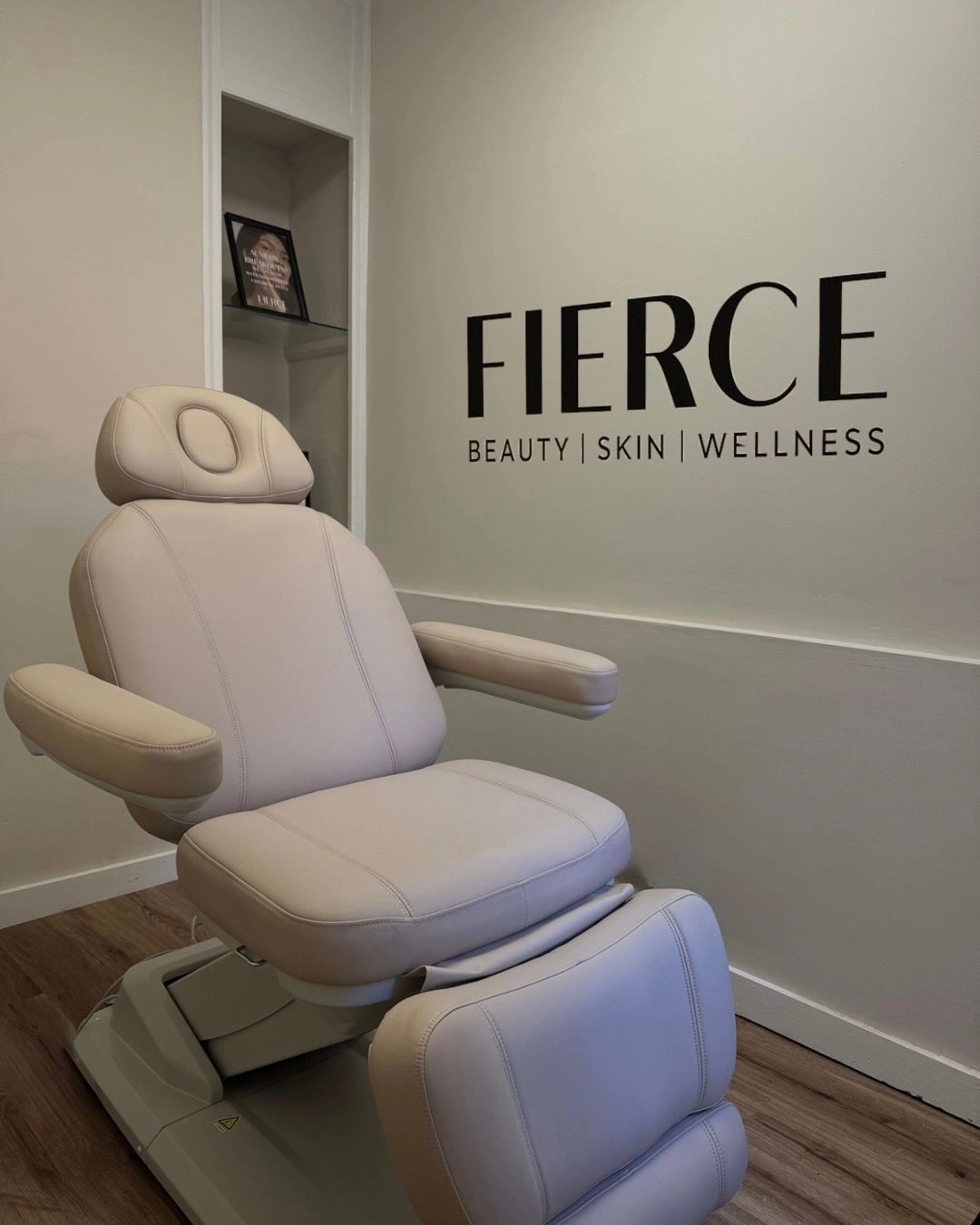 A modern beige treatment chair in a beauty and wellness clinic.