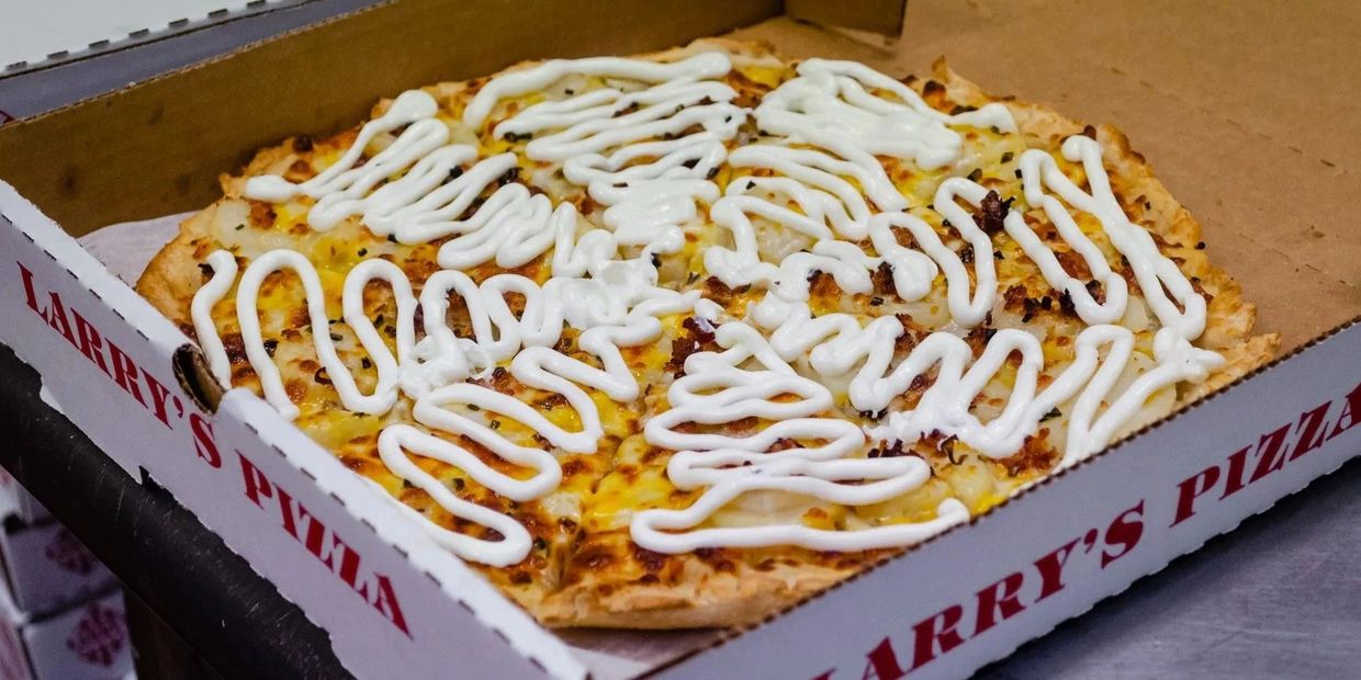 delicious pizza in a box with cheese on the top 