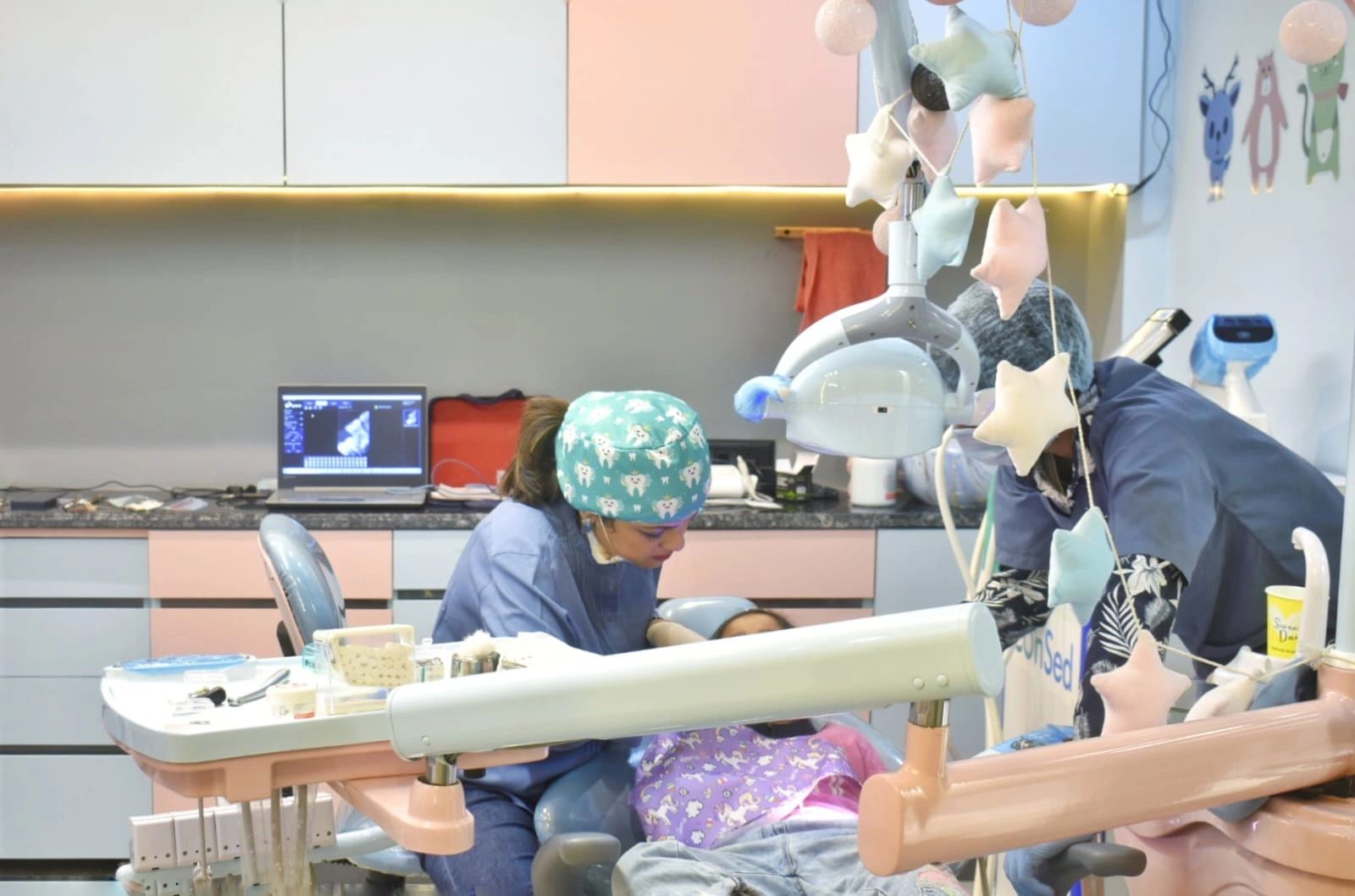 Dentist examining a child patient in a colorful dental clinic.