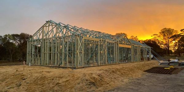 Wooden frame of a house at sunset.