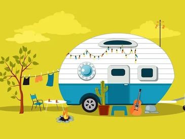 Retro camper with outdoor campfire and decorations in a yellow landscape.